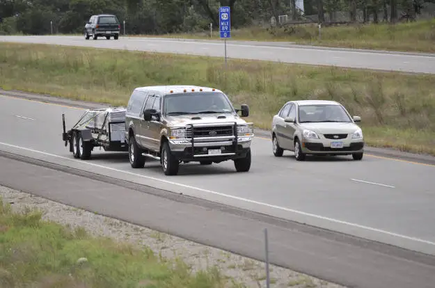 Car Passing Truck Towing Trailer