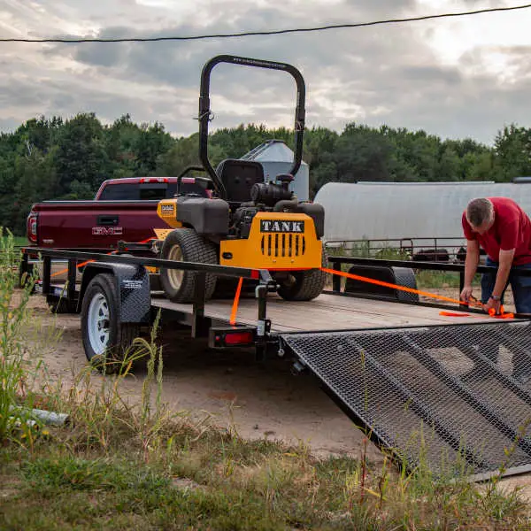 Flat-bed trailer pulling lawn tractor