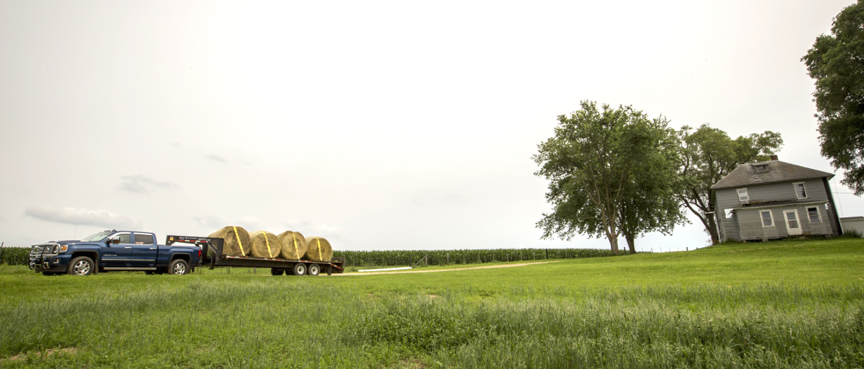 Farm truck towing flatbed trailer with CURT gooseneck hitch