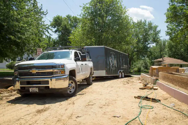 Work Truck Towing Enclosed Utility Trailer